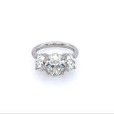 A platinum three stone oval cut diamond ring with a main oval-cut diamond flanked by two smaller, oval-cut diamonds, set in a platinum band.