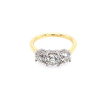 A three-stone diamond ring with a yellow gold band and a platinum prong setting, against a plain white background.