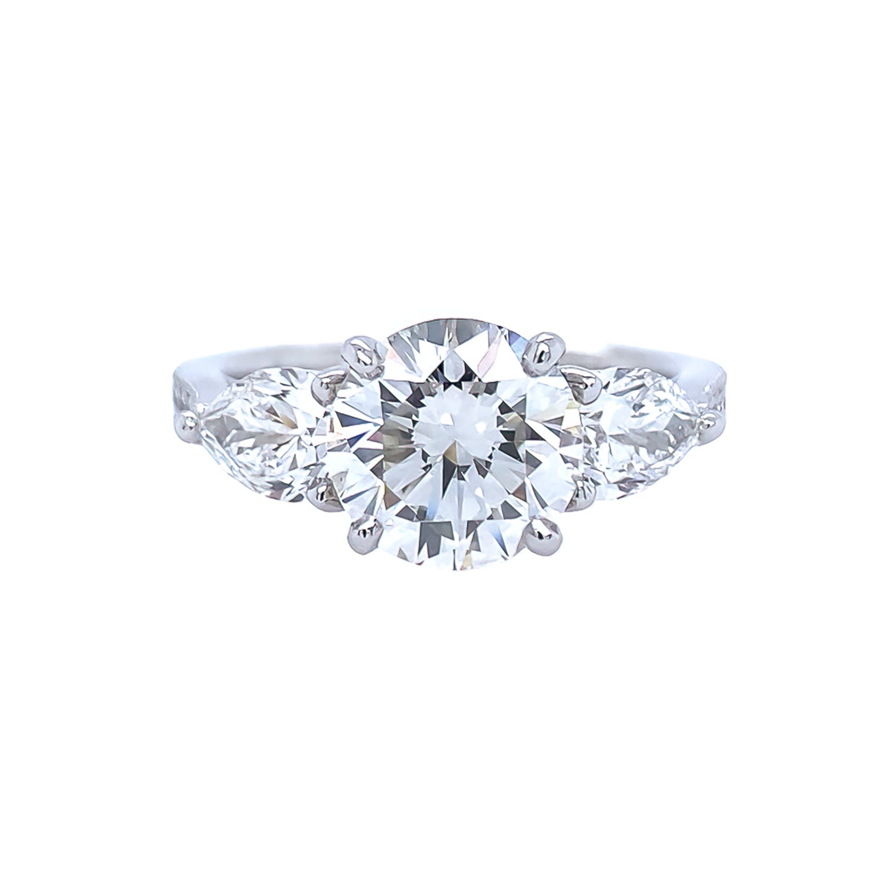 A platinum engagement ring with a central diamond and smaller diamonds set around it.