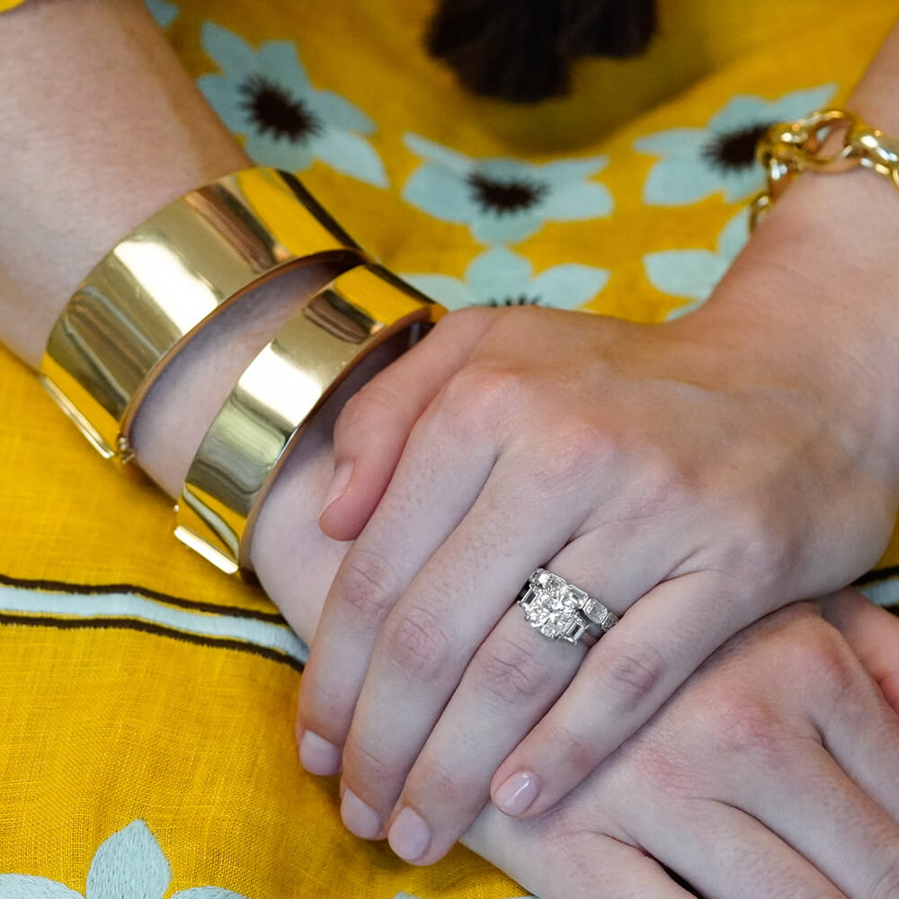 Woman wearing polished flat gold bangles