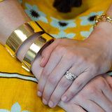 Woman wearing polished flat gold bangles