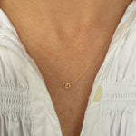 woman wearing a yellow gold dainty necklace