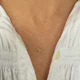 woman wearing a yellow gold dainty necklace