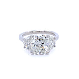 A custom designed radiant cut diamond ring with half moon sides, set in a platinum band