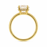 An 18K yellow gold ring with a large clear round-cut center diamond and a hidden halo of small clear diamonds shown against a plain white background.