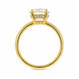 An 18K yellow gold ring with a large clear round-cut center diamond and a hidden halo of small clear diamonds shown against a plain white background.
