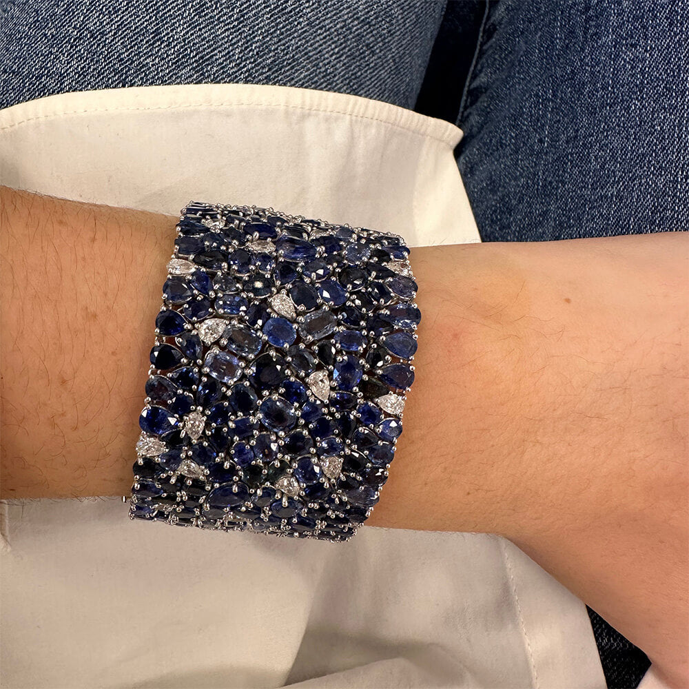 Close-up of a sparkling blue sapphire and diamond bracelet.