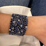 Close-up of a sparkling blue sapphire and diamond bracelet.
