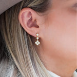 Close-up of 18k yellow gold and diamond Sarah drop earrings. 