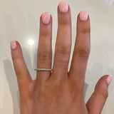 Woman wearing a shared prong set diamond eternity band 0.68 carats