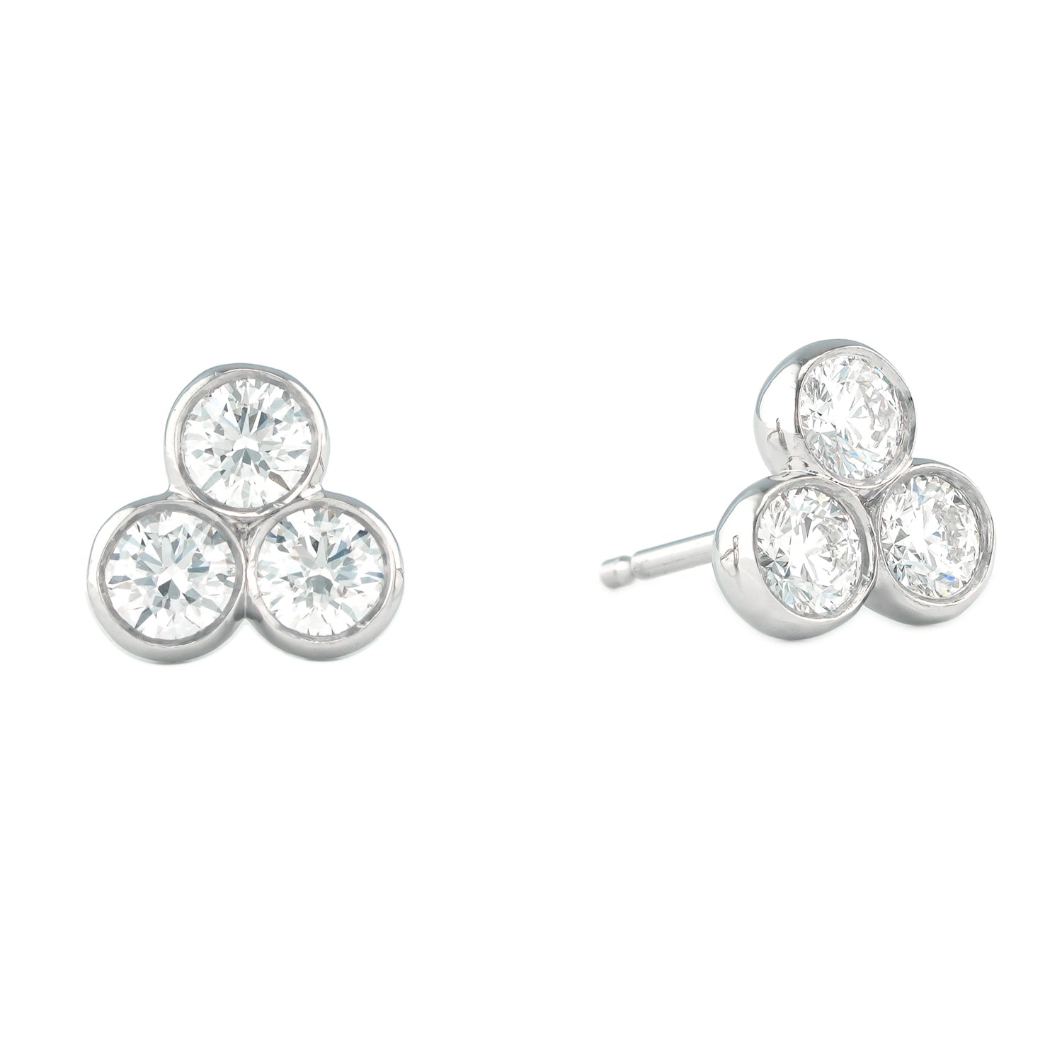 Pair of silver earrings with three diamonds on a white background