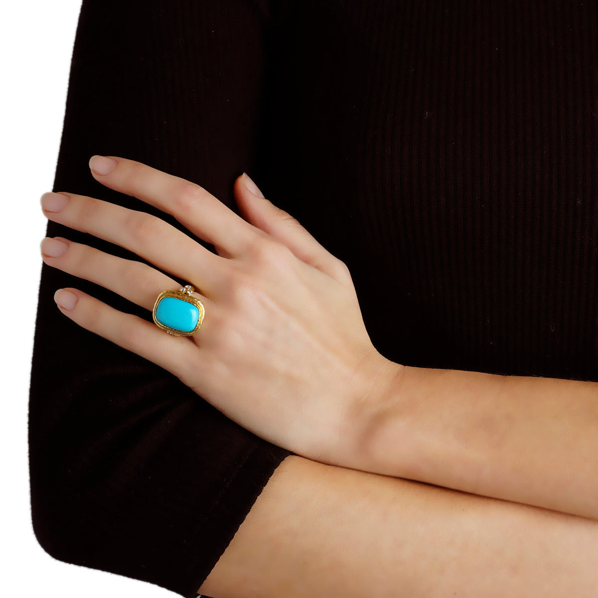 Woman wearing a Sleeping Beauty turquoise ring designed by Elizabeth Locek