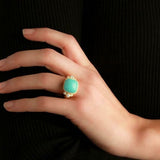 Woman wearing an Elizabeth Locke turquoise ring with gold band 