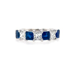 A platinum band featuring square blue sapphire and diamond stones.