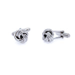 A pair of sterling silver knot cufflinks with a reflective surface.