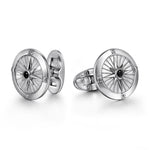 Silver cufflinks with intricate design on a white background