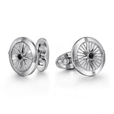 Silver cufflinks with intricate design on a white background