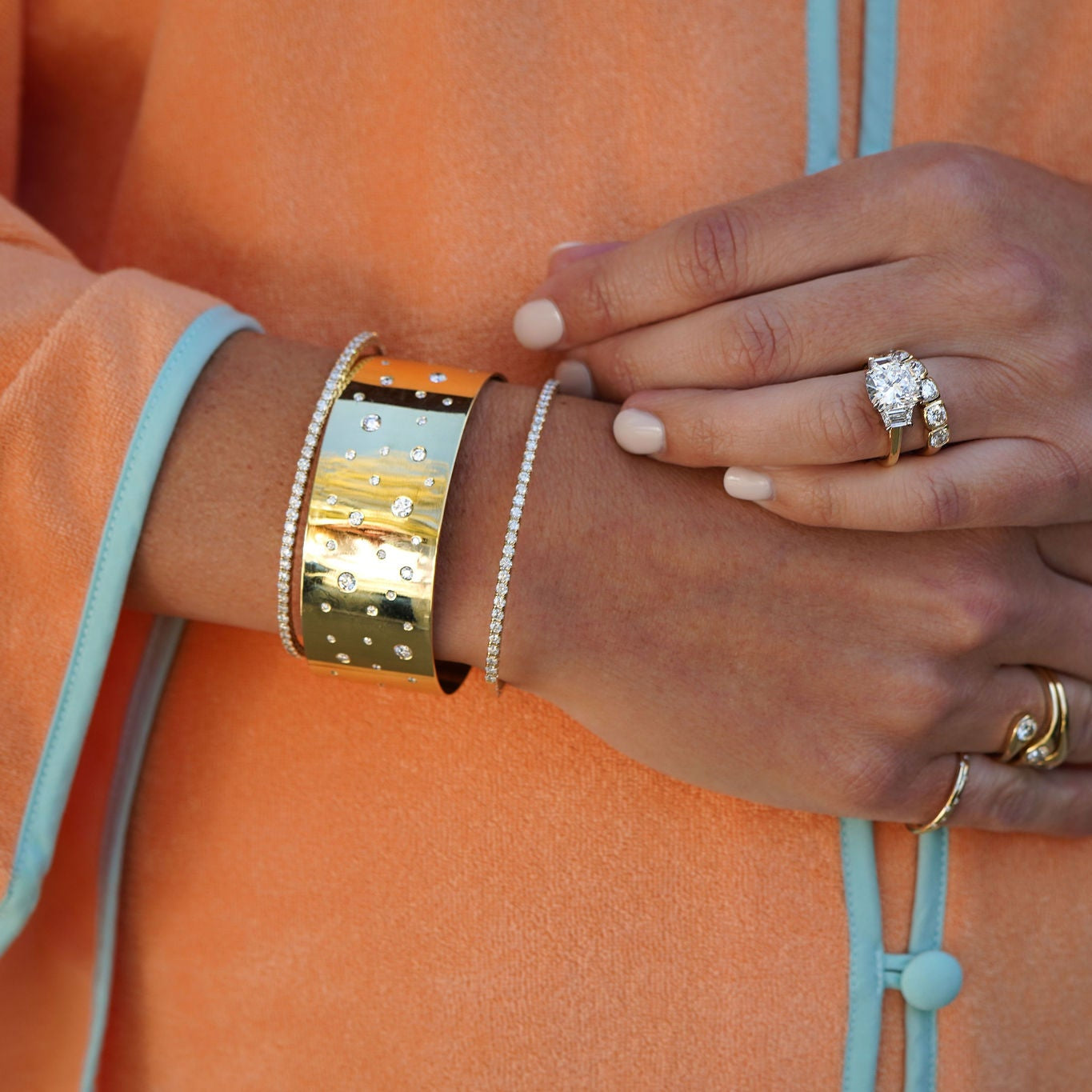 Woman wearring the Susan 18K gold cuff bracelet with many flush set diamonds