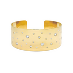 An 18K yellow gold cuff bracelet with several flush set diamonds