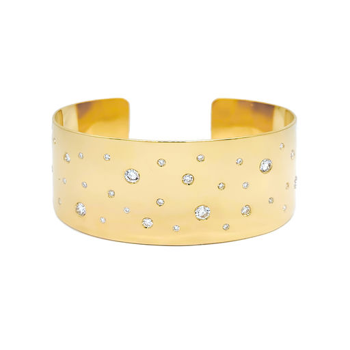An 18K yellow gold cuff bracelet with several flush set diamonds