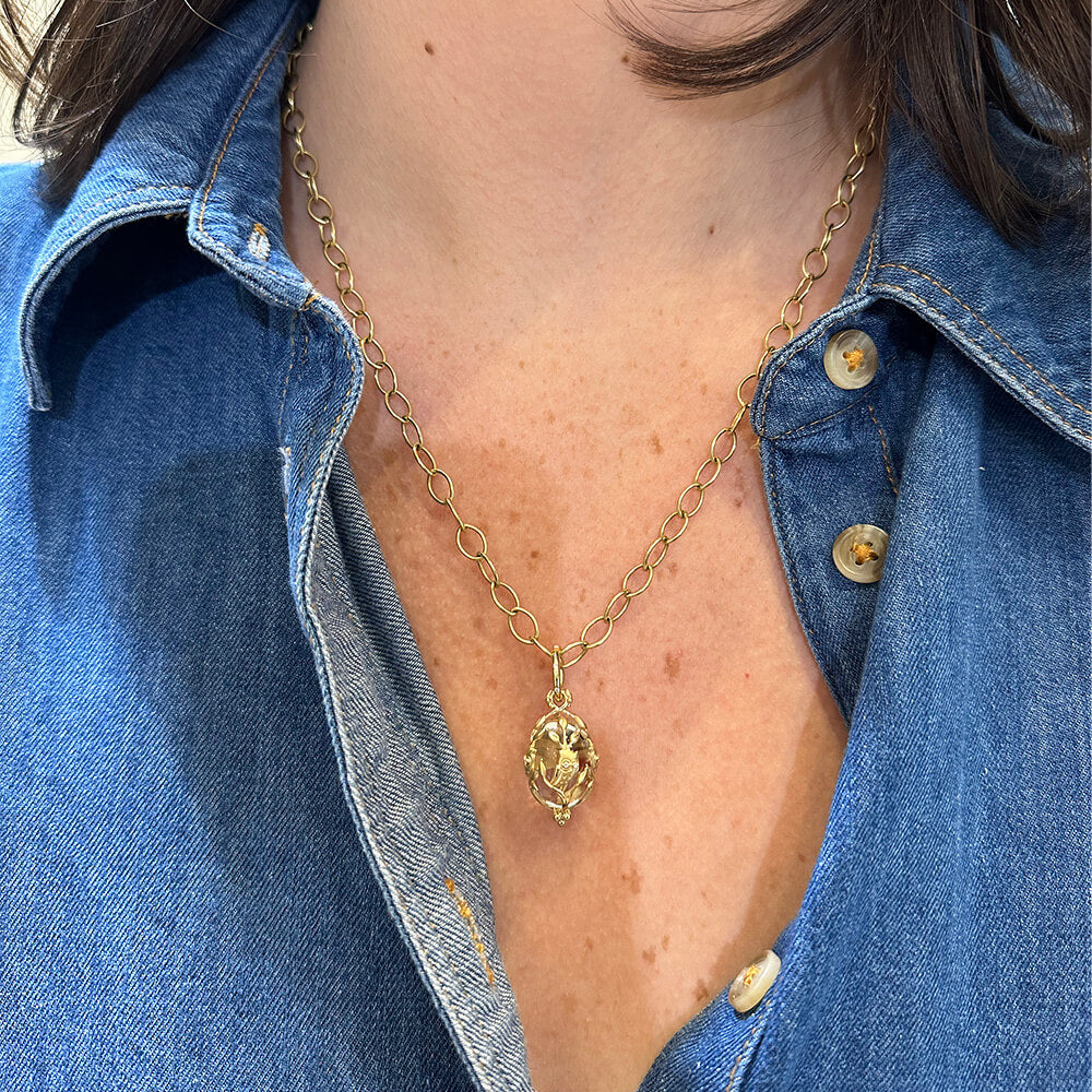 Woman wearing a Temple St Clair small owl amulet necklace