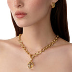 Woman wearing Temple St Clair 18K gold Arcadia Amulet on a gold chain necklace