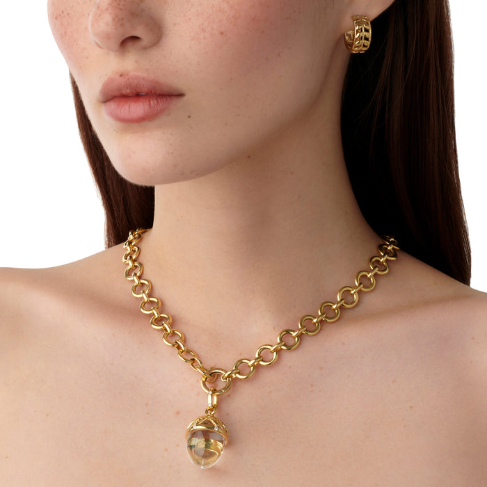 Woman wearing Temple St Clair 18K gold Arcadia Amulet on a gold chain necklace