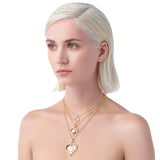 Woman wearing 3 sizes available of Temple heart-shaped pendants 