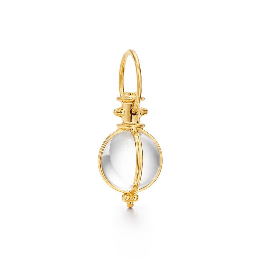 An 18K yellow gold small round rock amulet with a white crystal designed by Temple St Clair