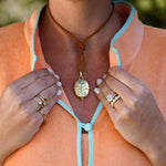 Woman wearing a Temple St Clair natural leather cord necklace with a pendant