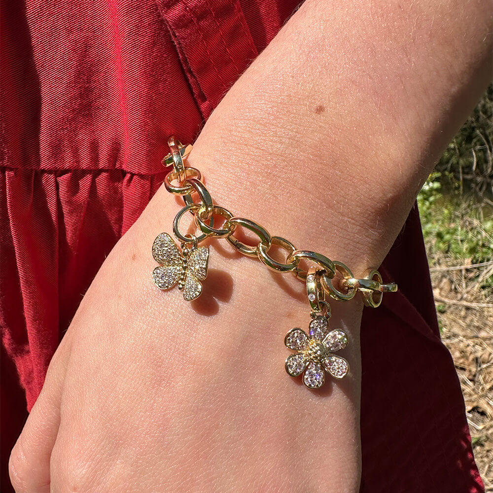 Woman wearing Temple St Clair 18K gold Snow Flower Pendant on a bracelet