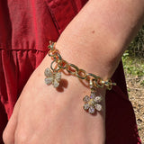 Woman wearing Temple St Clair 18K gold Snow Flower Pendant on a bracelet