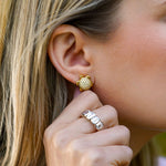 Close-up of a woman wearing gold Turtle earrings with diamonds desiigned by Temple St Clair