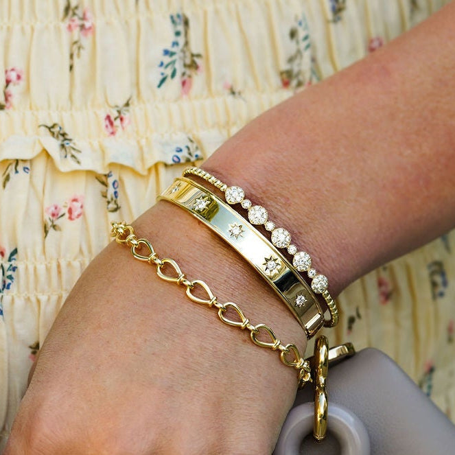 Woman wearing several gold bracelets