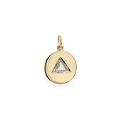 round yellow gold disc with one diamond trillion placed in the center