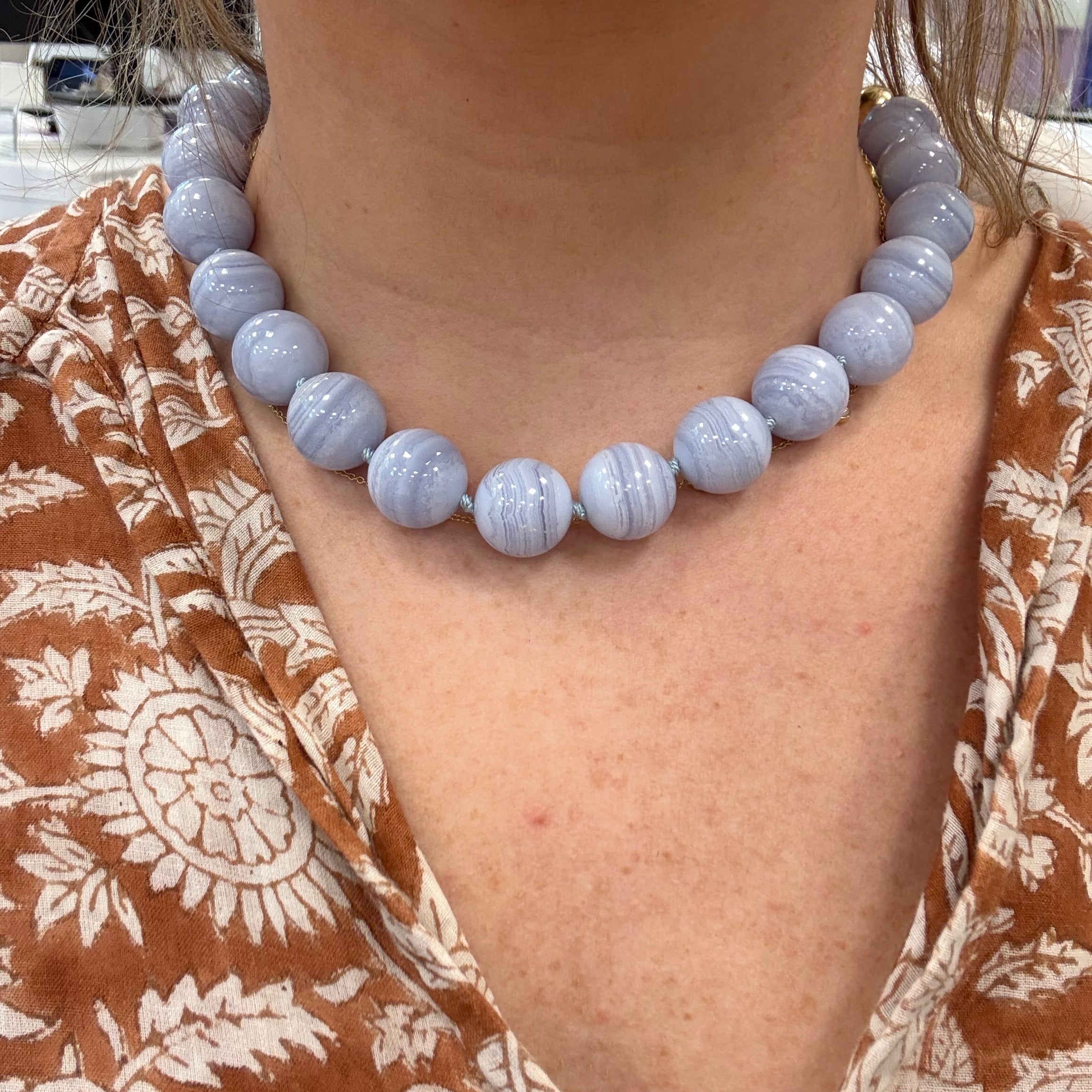 blue agate bead necklace on person