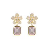 A pair of 18K yellow gold flower-shaped drop earrings adorned with clear pavé diamonds and a large rectangular pale pink amethyst gemstone below, shown on a plain white background.