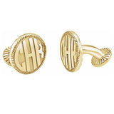 A pair of gold-colored cufflinks with intricate details and monogrammed initials.