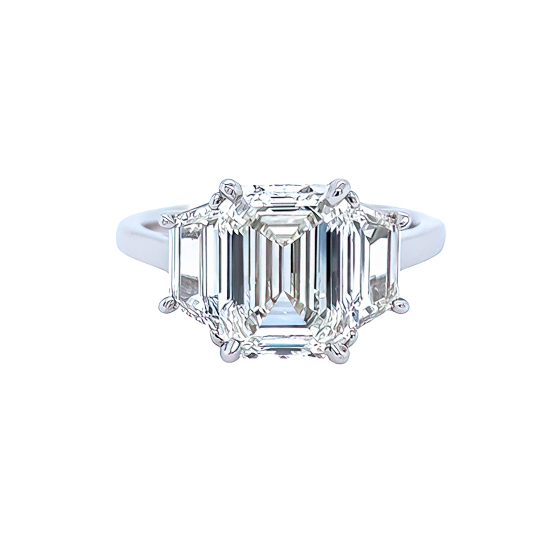 A custom designed platinum diamond ring with a central emerald cut diamond and smaller diamonds set around it.