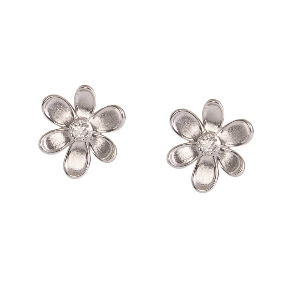 A pair of 18K white gold flower stud earrings with a textured petal design and a clear round diamond center, shown on a plain white background.