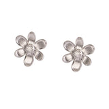 A pair of 18K white gold flower stud earrings with a textured petal design and a clear round diamond center, shown on a plain white background.