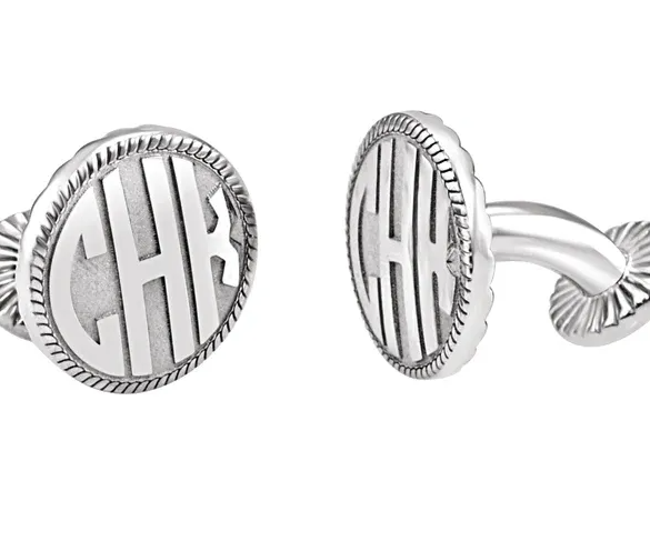 A pair of sterling silver cufflinks with a block monogram design.