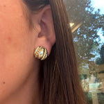 Close-up of a woman wearing a 14K gold estate earring 