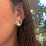 Close-up of a woman wearing a 14K gold estate earring 