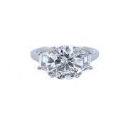 Platinum and round diamond ring with trapezoid side diamonds