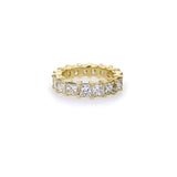 An 18K yellow gold eternity band ring with princess cut diamonds