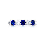sapphire and diamond band ring on platinum band on white background
