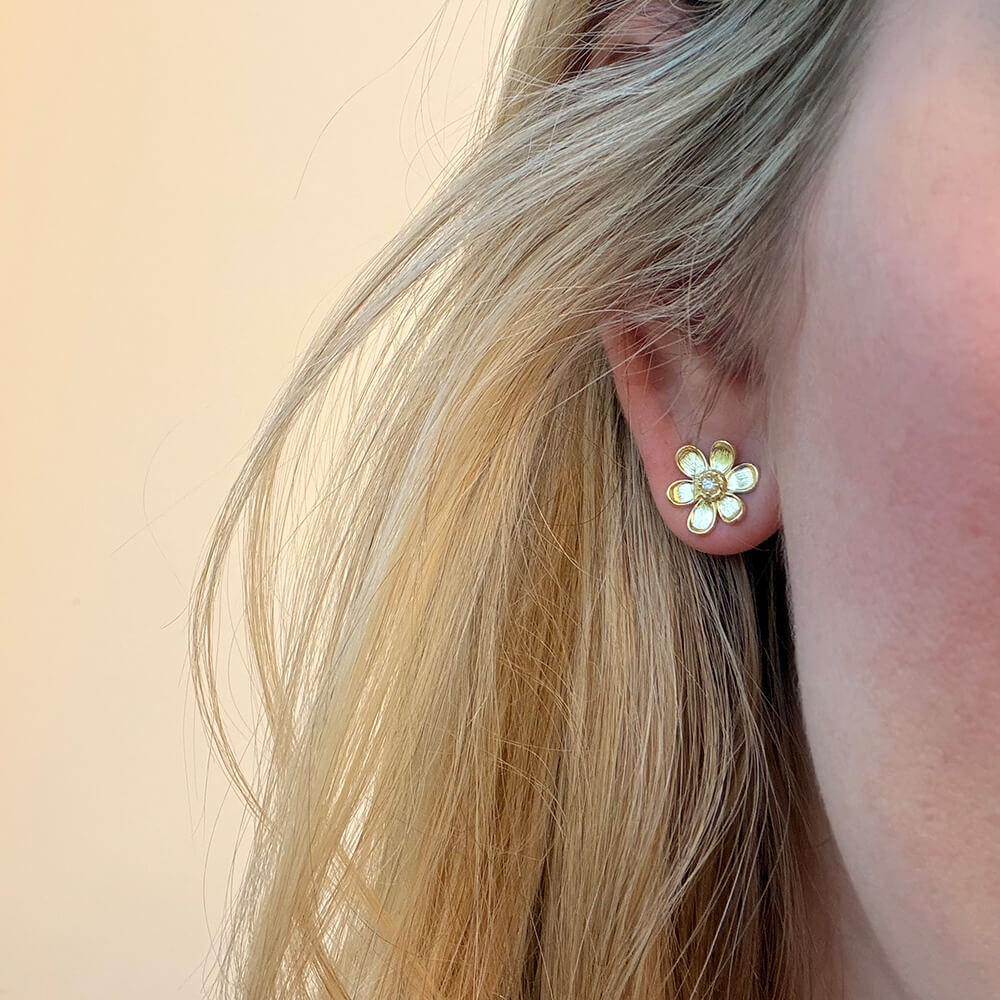 18K gold and diamond flower design stud earrings on modle