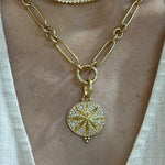 Woman wearing yellow gold Temple St. Clair necklace with a star-shaped pendant.