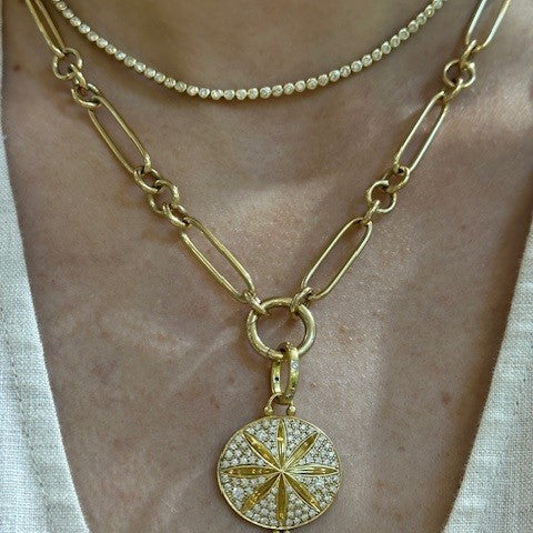 Woman wearing yellow gold Temple St. Clair necklace with a star-shaped pendant.
